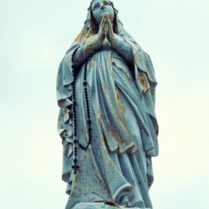 a statue of a woman holding her hands to her face